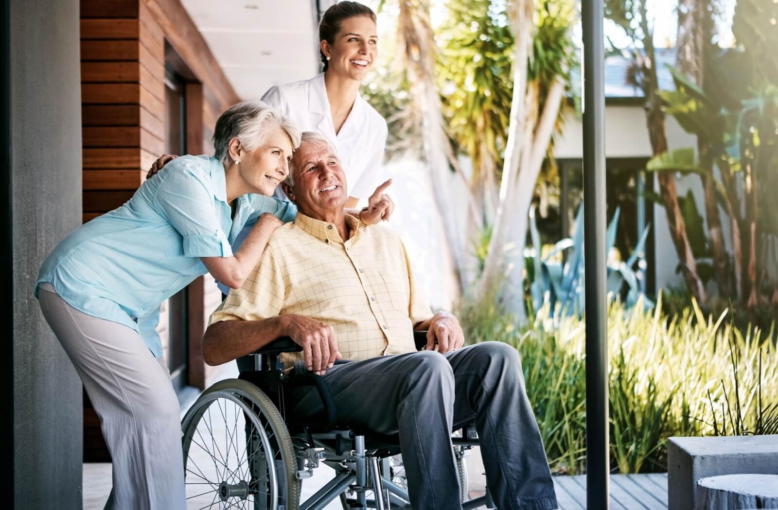 A senior couple tours a senior assisted living community with the aid of a part-time nurse to assess its accessibility